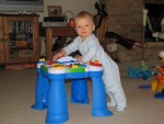Standing at his play table